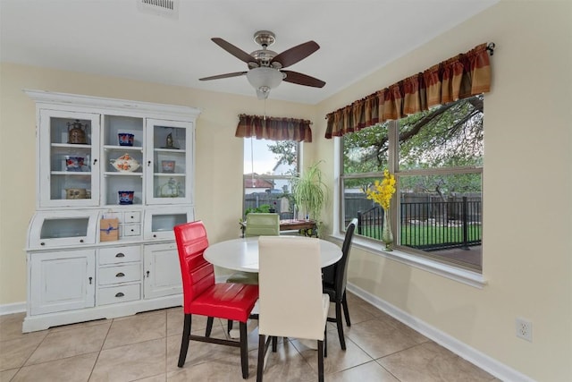 4932 Woodstock Dr, Georgetown, TX 78633 - dining space featuring light tile patterned floors, baseboards, and a ceiling fan