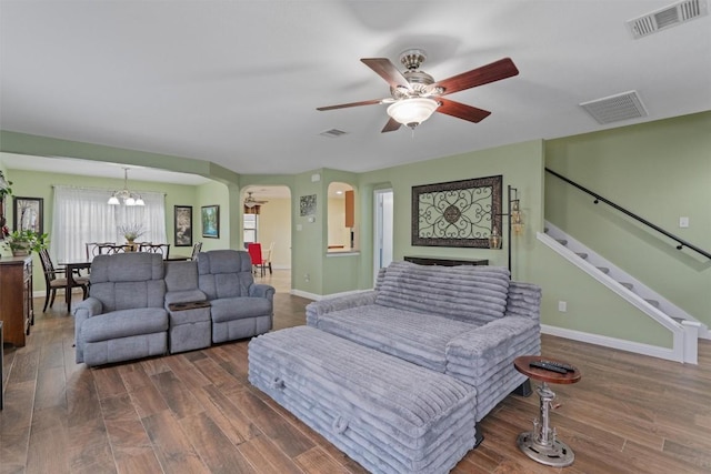4932 Woodstock Dr, Georgetown, TX 78633 - living room with arched walkways, baseboards, ceiling fan, and wood finished floors