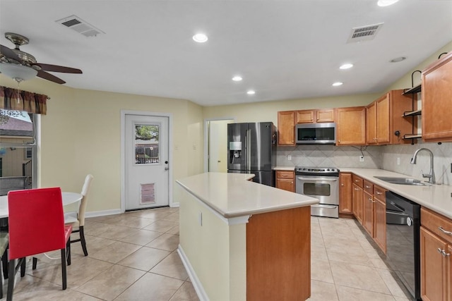 4932 Woodstock Dr, Georgetown, TX 78633 - kitchen with appliances with stainless steel finishes, a sink, ceiling fan, light tile patterned floors, and backsplash