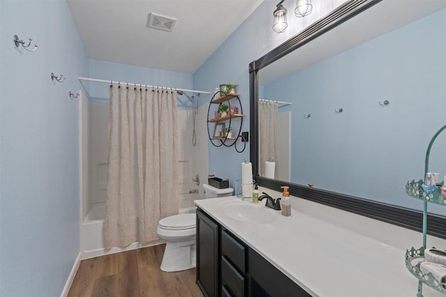 4932 Woodstock Dr, Georgetown, TX 78633 - bathroom with toilet, shower / bath combo, vanity, and wood finished floors