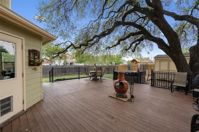 4932 Woodstock Dr, Georgetown, TX 78633 - wooden terrace with outdoor dining area and a fenced backyard