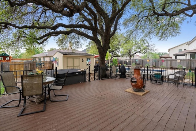 4932 Woodstock Dr, Georgetown, TX 78633 - wooden deck featuring a hot tub, outdoor dining area, and a fenced backyard