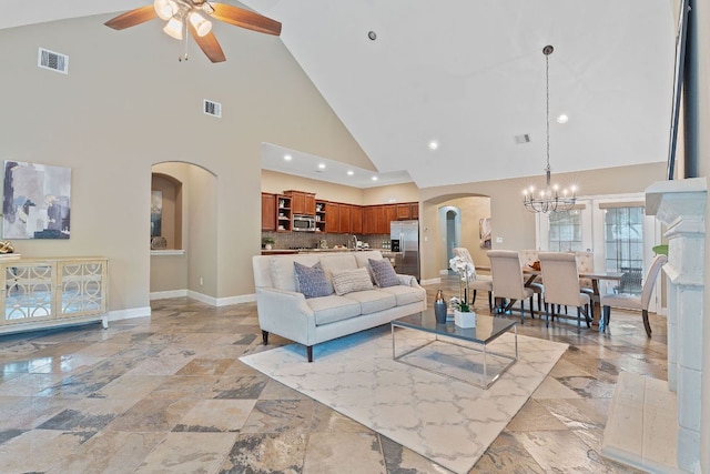 3985 Sapphire Loop, Round Rock, TX 78681 - living room with arched walkways, baseboards, visible vents, and ceiling fan with notable chandelier