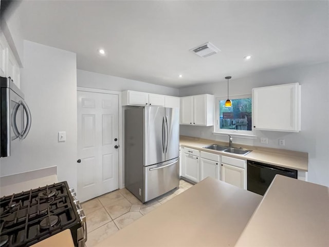 kitchen featuring white cabinets, visible vents, a sink, and appliances with stainless steel finishes
