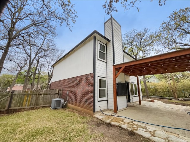 804 Dewberry Dr, Cedar Park, TX 78613 - view of side of property featuring a patio area, a chimney, and brick siding