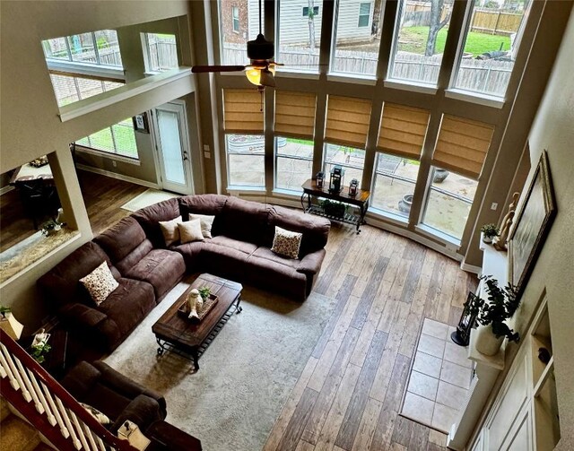30105 Meadow Greens Dr, Georgetown, TX 78628 - living area with a high ceiling, wood-type flooring, and ceiling fan