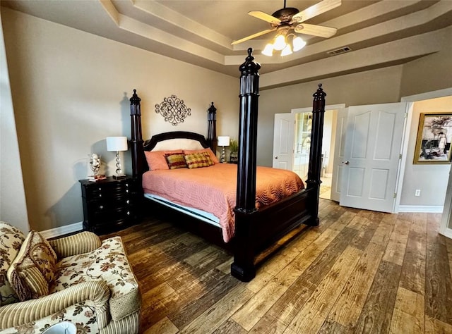 30105 Meadow Greens Dr, Georgetown, TX 78628 - bedroom with a raised ceiling and hardwood / wood-style flooring