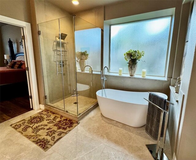 30105 Meadow Greens Dr, Georgetown, TX 78628 - ensuite bathroom featuring a soaking tub, a shower stall, and tile patterned flooring