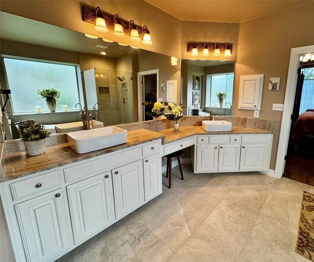30105 Meadow Greens Dr, Georgetown, TX 78628 - bathroom featuring a shower stall, vanity, and ensuite bathroom
