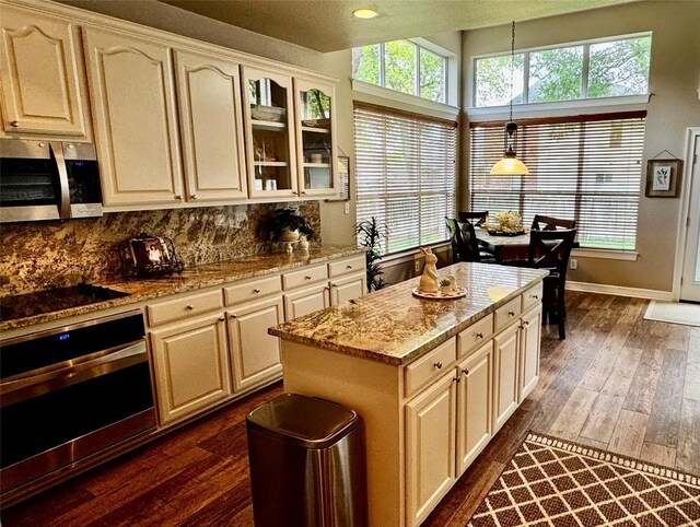 30105 Meadow Greens Dr, Georgetown, TX 78628 - kitchen featuring appliances with stainless steel finishes, dark wood finished floors, and backsplash