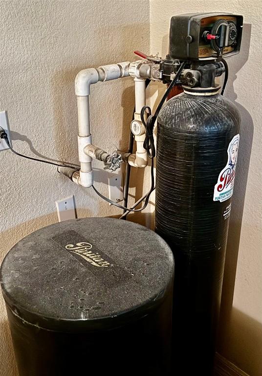 30105 Meadow Greens Dr, Georgetown, TX 78628 - detailed view of a textured wall and a water softener system