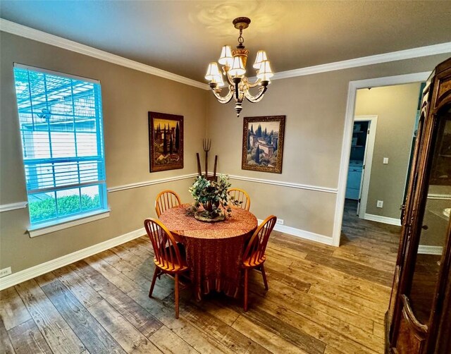 30105 Meadow Greens Dr, Georgetown, TX 78628 - dining room with a chandelier, hardwood / wood-style floors, and crown molding
