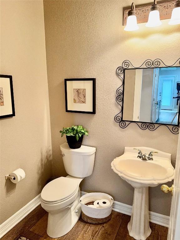 30105 Meadow Greens Dr, Georgetown, TX 78628 - bathroom with toilet and wood finished floors