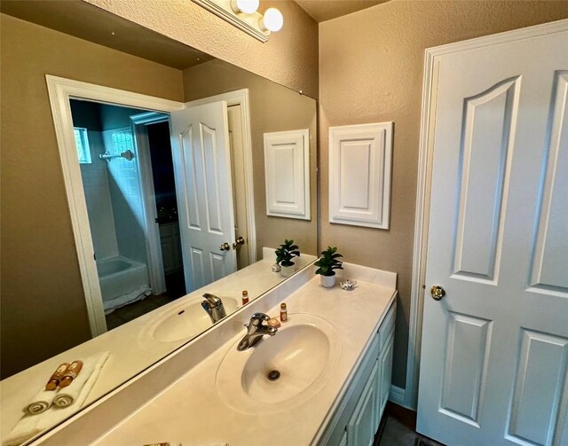 30105 Meadow Greens Dr, Georgetown, TX 78628 - full bath featuring vanity, a shower, and a textured wall