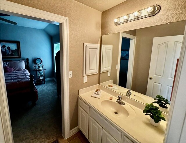 30105 Meadow Greens Dr, Georgetown, TX 78628 - bathroom with vanity, a textured wall, and ceiling fan