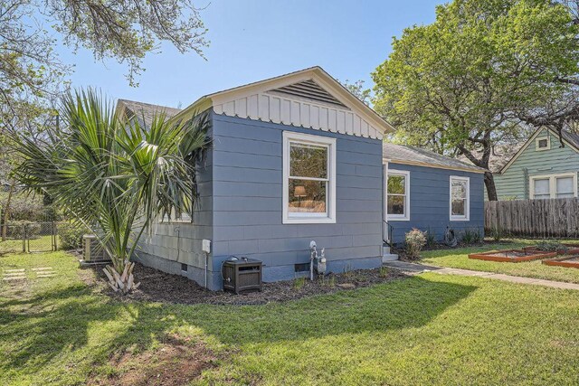 811 E 45th St, Austin, TX 78751 - view of home's exterior with crawl space, board and batten siding, and a vegetable garden