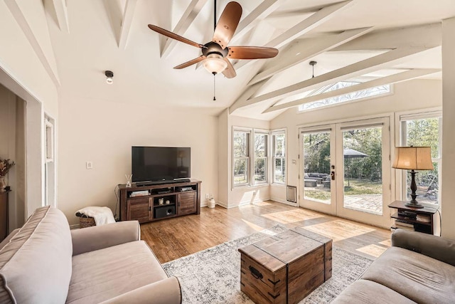 811 E 45th St, Austin, TX 78751 - living room featuring beam ceiling, wood finished floors, ceiling fan, french doors, and high vaulted ceiling