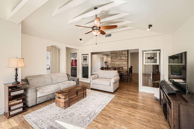 811 E 45th St, Austin, TX 78751 - living room with ceiling fan, beam ceiling, light wood-style flooring, baseboards, and high vaulted ceiling