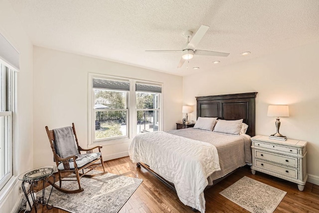 811 E 45th St, Austin, TX 78751 - bedroom with a textured ceiling, dark wood-style flooring, baseboards, a ceiling fan, and recessed lighting