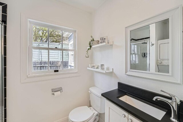 811 E 45th St, Austin, TX 78751 - bathroom with estacked washer and dryer, toilet, vanity, and a tile shower