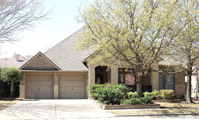 2718 Sun Mountain Dr, Leander, TX 78641 - view of front of house with brick siding, a garage, concrete driveway, and roof with shingles