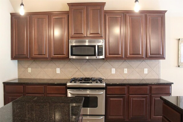 2718 Sun Mountain Dr, Leander, TX 78641 - kitchen featuring appliances with stainless steel finishes, tasteful backsplash, dark stone countertops, and decorative light fixtures