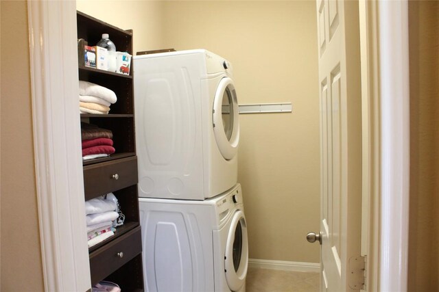 2718 Sun Mountain Dr, Leander, TX 78641 - laundry room featuring stacked washer / dryer and tile patterned floors