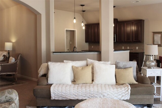 2718 Sun Mountain Dr, Leander, TX 78641 - tiled living room featuring baseboards and arched walkways