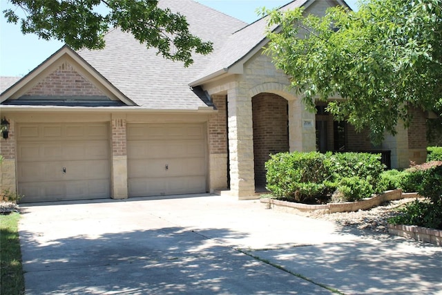 2718 Sun Mountain Dr, Leander, TX 78641 - view of front of home featuring brick siding, driveway, and a garage