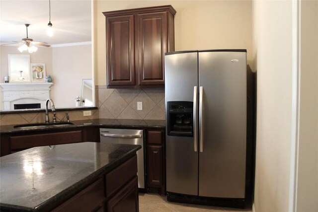 2718 Sun Mountain Dr, Leander, TX 78641 - kitchen with appliances with stainless steel finishes, a ceiling fan, backsplash, dark brown cabinetry, and dark stone counters