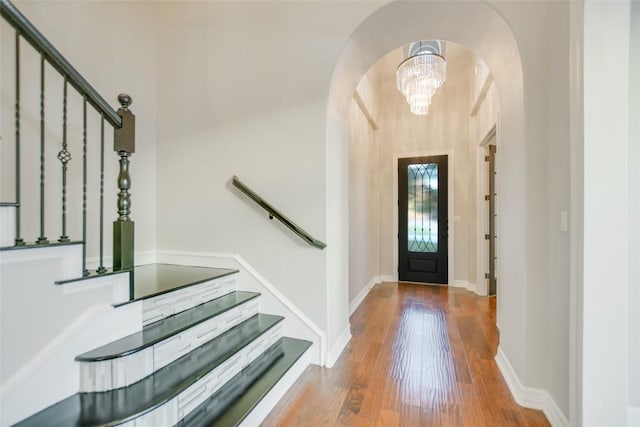 17100 Yellowstar Dr, Austin, TX 78738 - foyer with arched walkways, wood finished floors, stairs, and baseboards