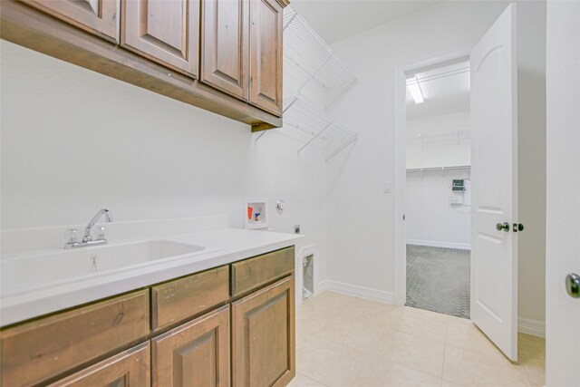17100 Yellowstar Dr, Austin, TX 78738 - laundry room featuring hookup for a washing machine, electric dryer hookup, cabinet space, baseboards, and light tile patterned floors