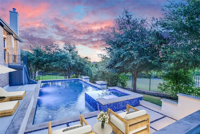 17100 Yellowstar Dr, Austin, TX 78738 - pool at dusk with a fenced backyard, a pool with connected hot tub, and a patio area