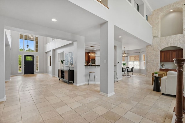 10408 Medinah Greens Dr, Austin, TX 78717 - entryway featuring light tile patterned floors, a high ceiling, a chandelier, baseboards, and recessed lighting