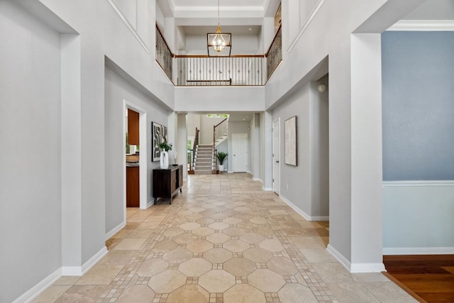10408 Medinah Greens Dr, Austin, TX 78717 - foyer with inlaid floor details, a chandelier, stairway, a high ceiling, and baseboards