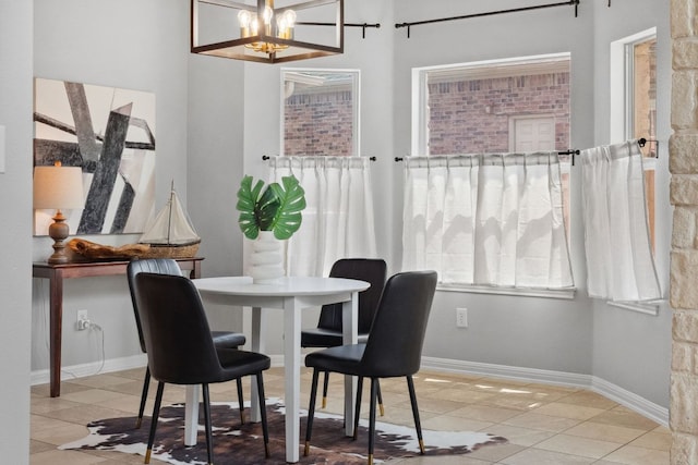 10408 Medinah Greens Dr, Austin, TX 78717 - dining room featuring tile patterned flooring, a chandelier, and baseboards