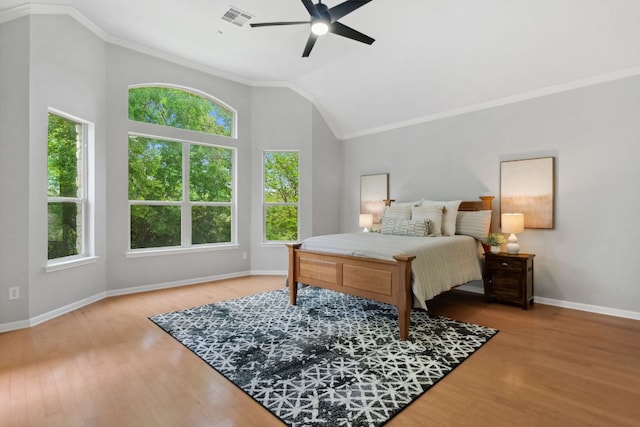 10408 Medinah Greens Dr, Austin, TX 78717 - bedroom with multiple windows, wood finished floors, crown molding, vaulted ceiling, and baseboards