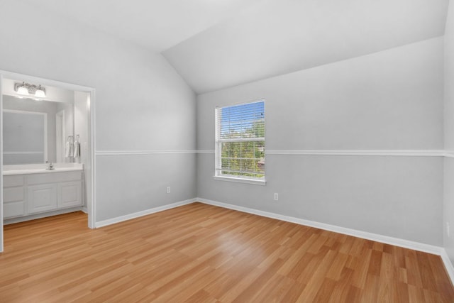 10408 Medinah Greens Dr, Austin, TX 78717 - unfurnished bedroom with light wood-style floors, vaulted ceiling, baseboards, ensuite bathroom, and a chandelier