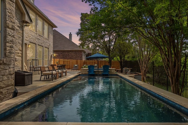 10408 Medinah Greens Dr, Austin, TX 78717 - pool at dusk with a patio and a fenced backyard