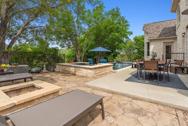 10408 Medinah Greens Dr, Austin, TX 78717 - fenced backyard featuring a hot tub, a patio area, outdoor dining space, and an outdoor fire pit