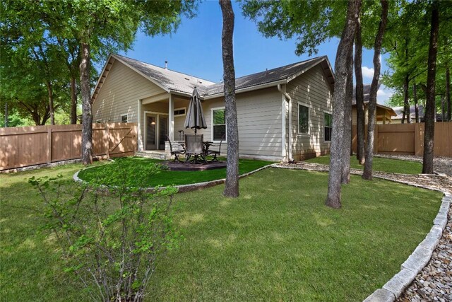 2433 Independence Dr Unit B105, Austin, TX 78745 - rear view of property with a lawn, a patio, and a fenced backyard