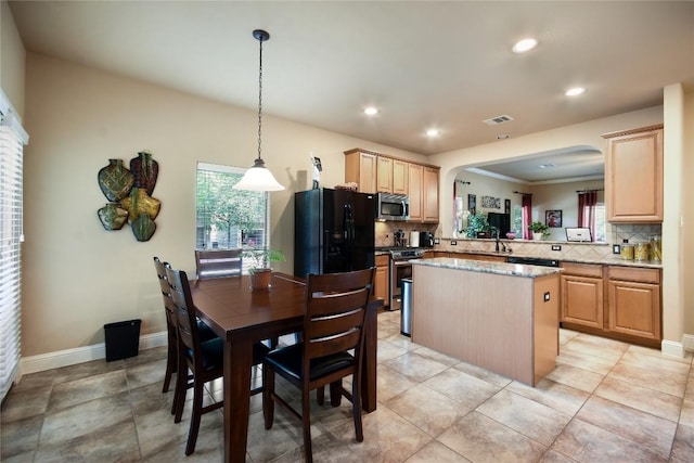 2433 Independence Dr Unit B105, Austin, TX 78745 - kitchen featuring light brown cabinetry, visible vents, backsplash, and appliances with stainless steel finishes