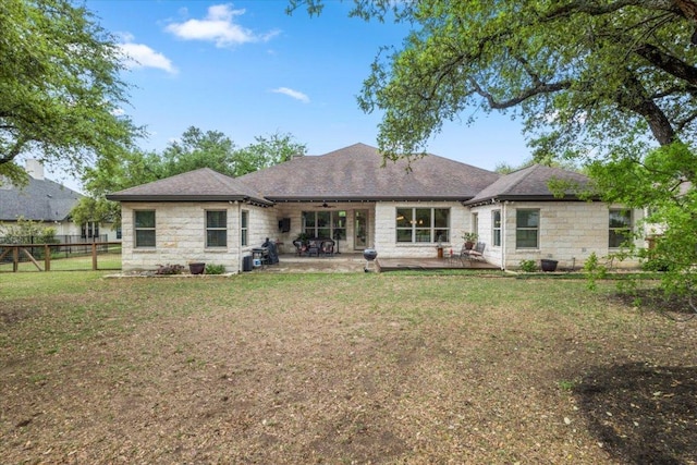 909 Highland Spring Ln, Georgetown, TX 78633 - rear view of property featuring a ceiling fan, stone siding, roof with shingles, and a patio