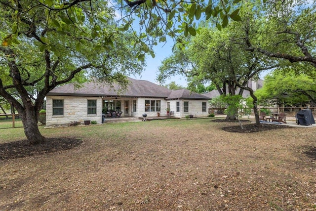 909 Highland Spring Ln, Georgetown, TX 78633 - rear view of house featuring stone siding and a patio area