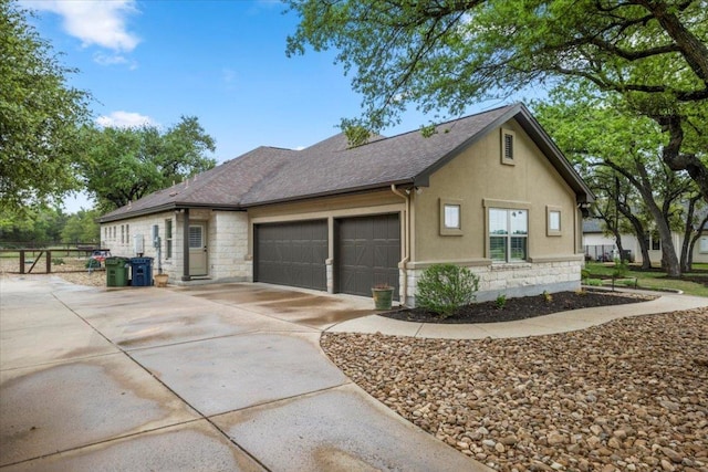909 Highland Spring Ln, Georgetown, TX 78633 - view of front facade with stone siding, an attached garage, driveway, and stucco siding