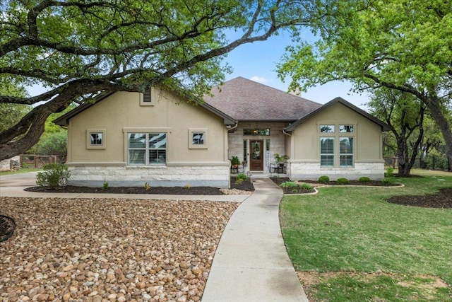 909 Highland Spring Ln, Georgetown, TX 78633 - view of front facade with stone siding, stucco siding, and a front lawn