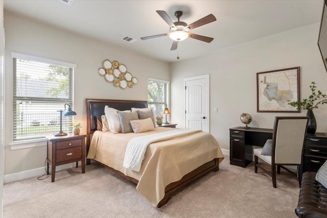 909 Highland Spring Ln, Georgetown, TX 78633 - bedroom featuring multiple windows, light carpet, baseboards, and ceiling fan