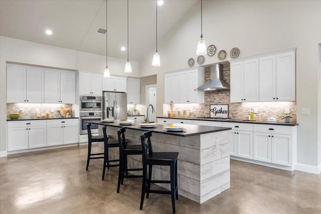 909 Highland Spring Ln, Georgetown, TX 78633 - kitchen with wall chimney range hood, finished concrete floors, stainless steel appliances, high vaulted ceiling, and dark countertops