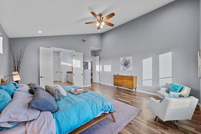 bedroom featuring high vaulted ceiling, a ceiling fan, wood finished floors, baseboards, and visible vents