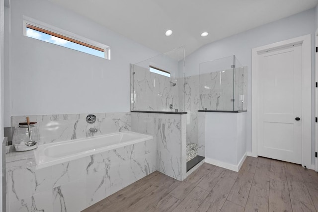 full bath with a bath, a marble finish shower, wood finished floors, recessed lighting, and lofted ceiling